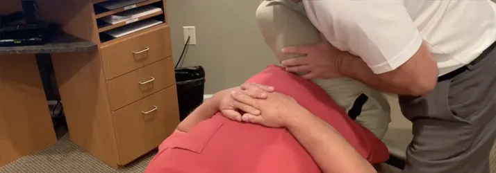 Chiropractor Frederick MD Sebastian Lipinski Adjusting Hip Pain Patient Chiropractor Frederick MD Sebastian Lipinski Adjusting Hip Pain Patient