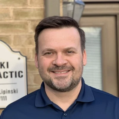 Chiropractor Frederick MD Sebastian Lipinski 1 Sebastian Lipinski smiling in a blue shirt.